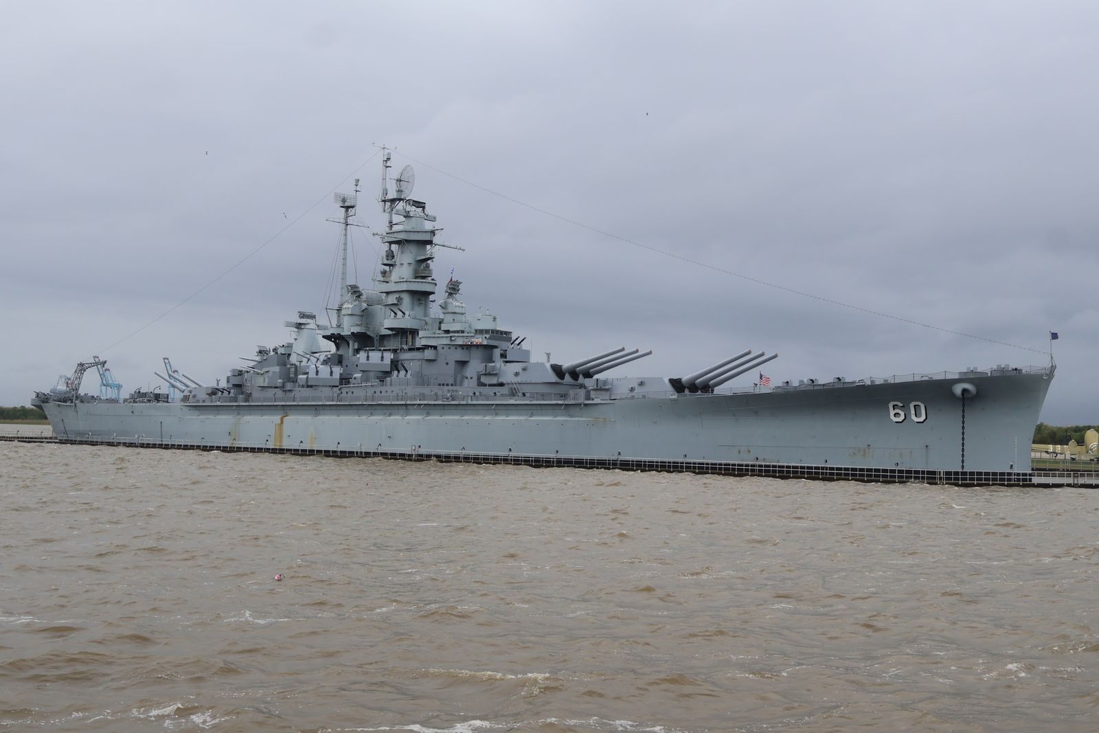 The battleship USS Alabama moored at Battleship Memorial Park in Mobile under a gray sky